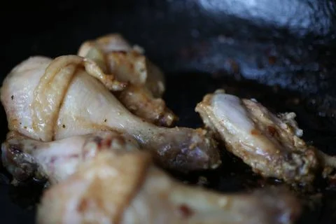 Frying chicken in a pan Stock Photos