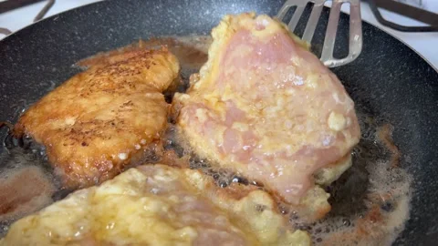 Frying chicken in a pan using a spatula. Stock Footage 209896665