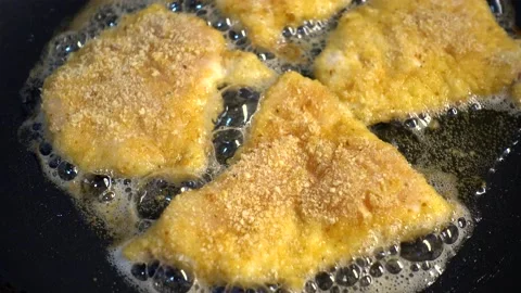 Frying chicken pieces in a pan with vegetable oil Stock Footage 165103488