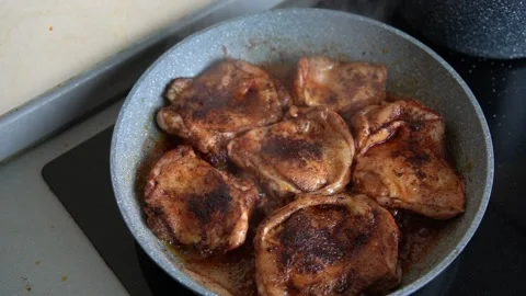 Frying chicken thighs on pan Stock Footage 161158927