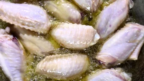Frying chicken wings in pan, in door Chiangmai Thailand. Stock Footage 304394993