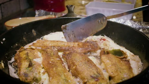 Frying Chile Rellenos in a Cast Iron Skillet Stock Footage 139788049