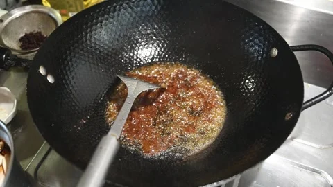 Frying Chili and Fermented Bean Paste in Hot Oil Stock Footage 346487985