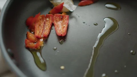 Frying Chili Pepper with Garlic on Olive Oil Stock-Footage 249830634