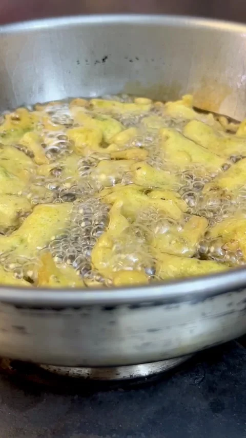 Frying chilli pakore or pakora in a frying pan or wok. Stock Footage 287435806