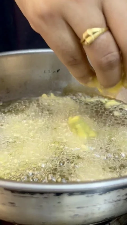Frying chilli pakore or pakora in a frying pan or wok. Stock Footage 287435811