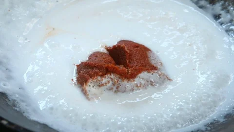 Frying chilli paste  with coconut milk to make Thai curry Stock Footage 89856171