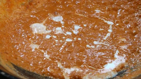 Frying chilli paste  with coconut milk to make Thai curry Stock Footage 89856172