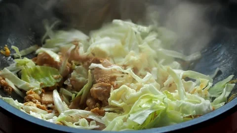 Frying chopped cabbage with chopped chicken in pan, in door Chiangmai Thailand. Stock Footage 255703225