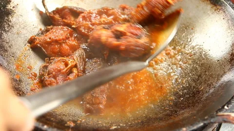 Frying chopped cat fish  with chili  in pan , in door  Chiangmai  Thailand Stock Footage 138627932