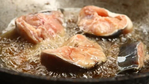 Frying chopped cat fish  in pan , in door  Chiangmai  Thailand Stock Footage 138628074