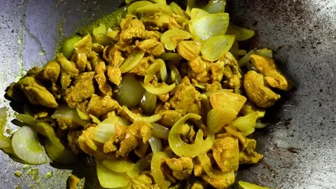 Frying chopped chicken with onion in pan, in door  Chiangmai  Thailand. Stock Footage 310365294