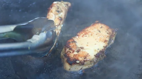 Frying  chopped chicken in pan, in door  Chiangmai  Thailand Stock Footage 145924936