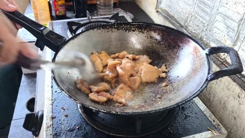 Frying chopped chicken in pan, in door  Chiangmai  Thailand. Stock Footage 294953599