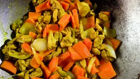 Frying chopped chickens with vegetables in pan Stock Footage 310365322