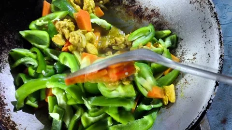 Frying chopped chickens with vegetables in pan, in door  Chiangmai  Thailand. Stock Footage 310365550