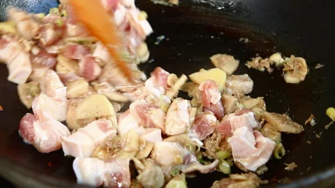 Frying chopped chopped streaky pork with chili paste  in pan, in door  Chiangmai Video stock 163332379