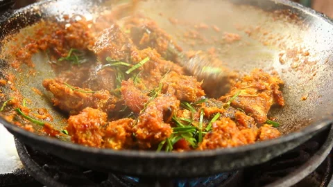 Frying  chopped head snake  fish with chili paste  in pan , in door  Chiangmai   Stock Footage 139816189