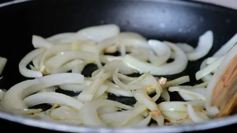 Frying chopped onion in frying pan. Cooking pasta sauce. Close up Stock Footage 157752609