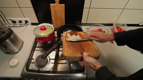 Frying chopped onion on hot pan authentic home kitchen cooking process with Stock Footage 316470058