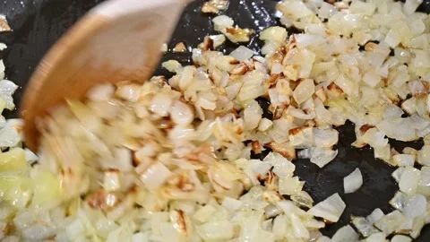 Frying chopped onion in a pan Stock Footage 219674332