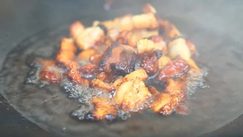Frying  chopped pork fat in pan, in door  Chiangmai Thailand Stock Footage 165581118