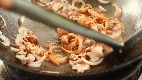 Frying chopped pork with red onion in pan, outdoor Chiangmai Thailand Stock Footage 141430976