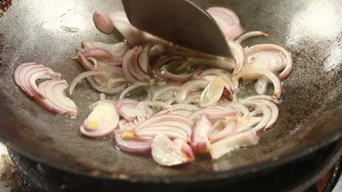 Frying chopped red onion in pan, in door  Chiangmai  Thailand Stock Footage 141430423