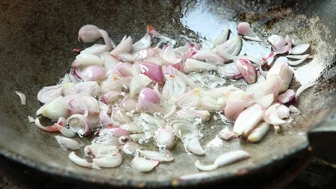 Frying chopped shallot in pan, in door Chiangmai Thailand Stock Footage 128135406