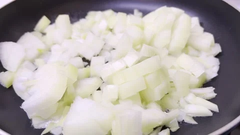 Frying chopped white onion in frying pan. Close up. 動画素材 168367400