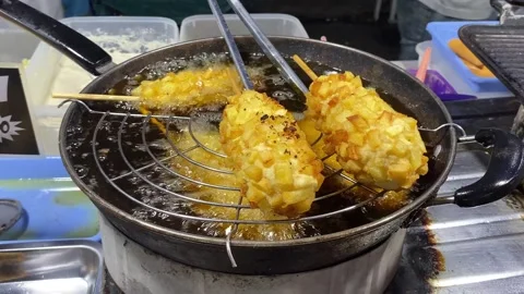 Frying Corndogs at a Night Market Stock Footage 288057800