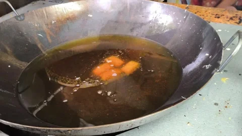 Frying Crispy Spring Rolls in Hot Oil Inside Large Wok Stock Footage 329266652