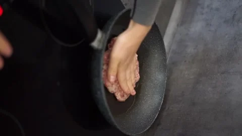 Frying a cutlet in a frying pan vertical video Stock Footage 257562422