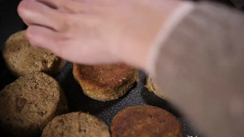 Frying cutlets in a pan. The cook turns them over with a spatula. Stock Footage 157932465