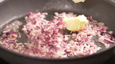 Frying cutted onion on hot  butter. Stock Footage 138468139