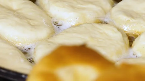 Frying Delicious Donut-Like Bread in Vegetable Oil Stock Footage 278957976