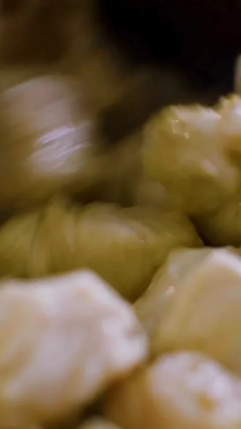 Frying diced chicken pieces in a hot pan Stock-Footage 334168449