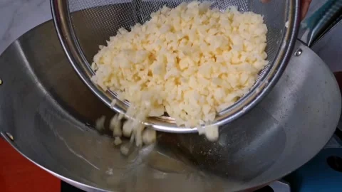 Frying Diced Potatoes in a Big Wok with Some Cooking Oil Stock Footage 241511471