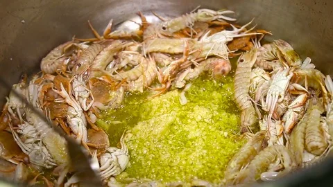 Frying of different seafood with garlik in big pan. Close up Stock Footage 74523461