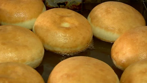 Frying donuts in boiling oil Stock Footage 99614054