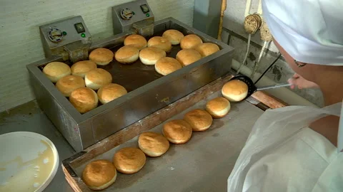 Frying donuts in boiling oil Stock Footage 99614373