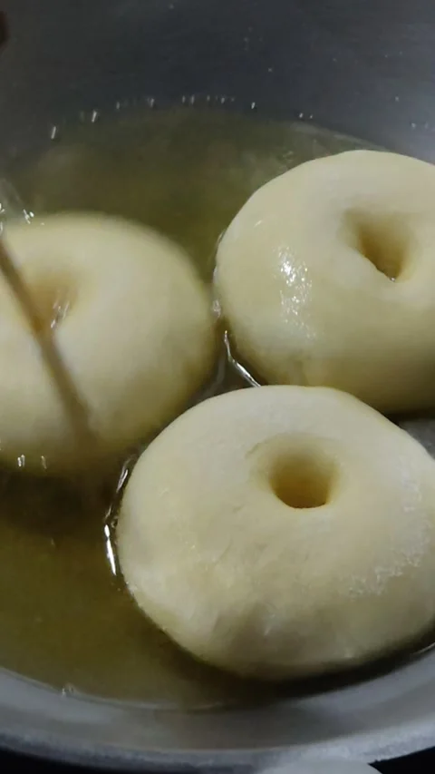 Frying donuts in hot oil Stock Footage 284841047