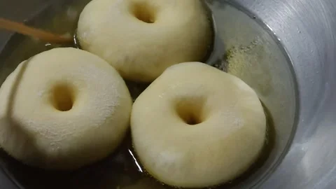 Frying donuts in hot oil Stock Footage 284841081