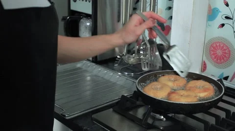Frying donuts in a kitchen, detail of a kitchen, sweet dessert Stock-Footage 68908905