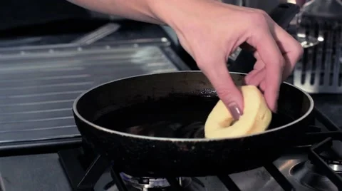 Frying donuts in a kitchen, detail of a kitchen, sweet dessert Stock Footage 68908958