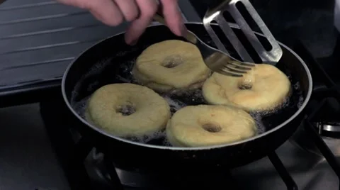 Frying donuts in a kitchen, detail of a kitchen, sweet dessert Stock Footage 68908961
