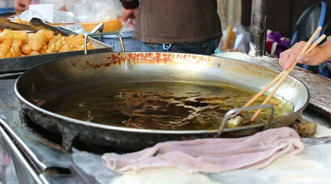 Frying dough stick in a hot pan Stock Footage 39017719