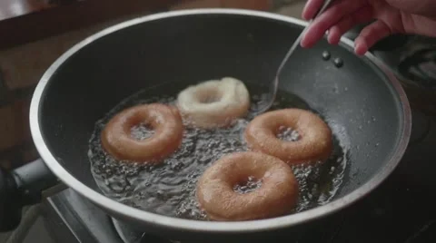 Frying doughnuts in big pan Stock Footage 60688973
