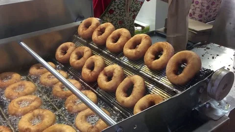 Frying dougnuts pastries in kitchen industrial fryer Stock Footage 81505460