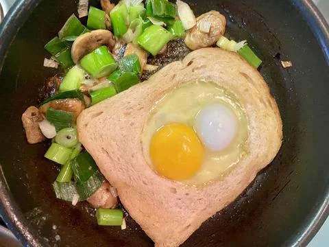 Frying an egg for breakfast Stock Photos